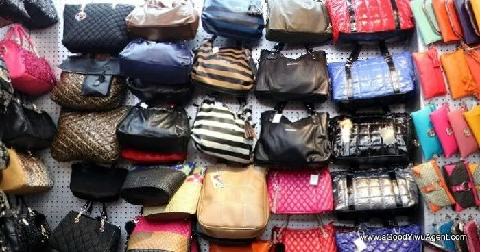 Wholesale bags, purses, and luggage displayed for resale and export distribution.